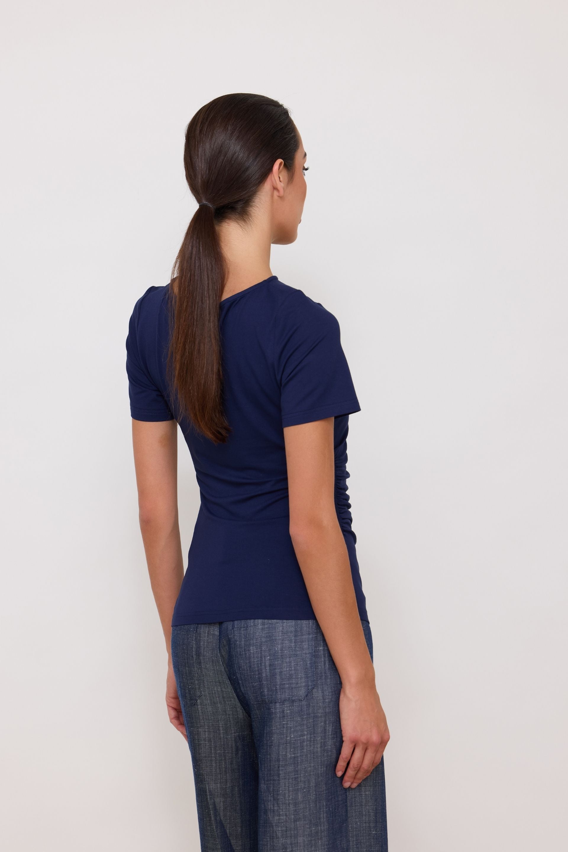 Navy blue short-sleeved blouse with draped sides