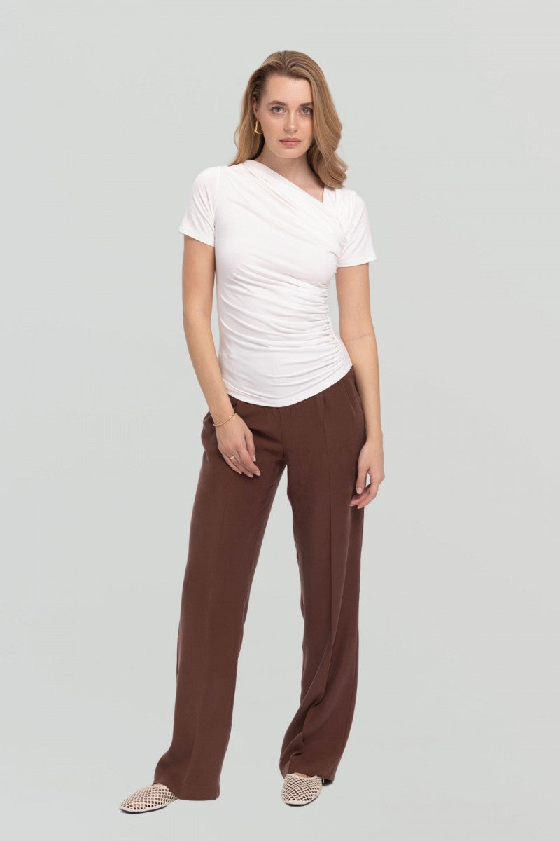Cream blouse with asymmetric neckline and draping