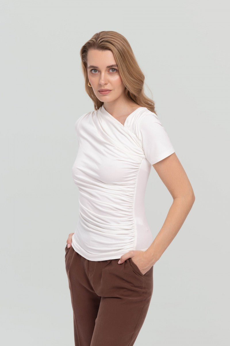 Cream blouse with asymmetric neckline and draping