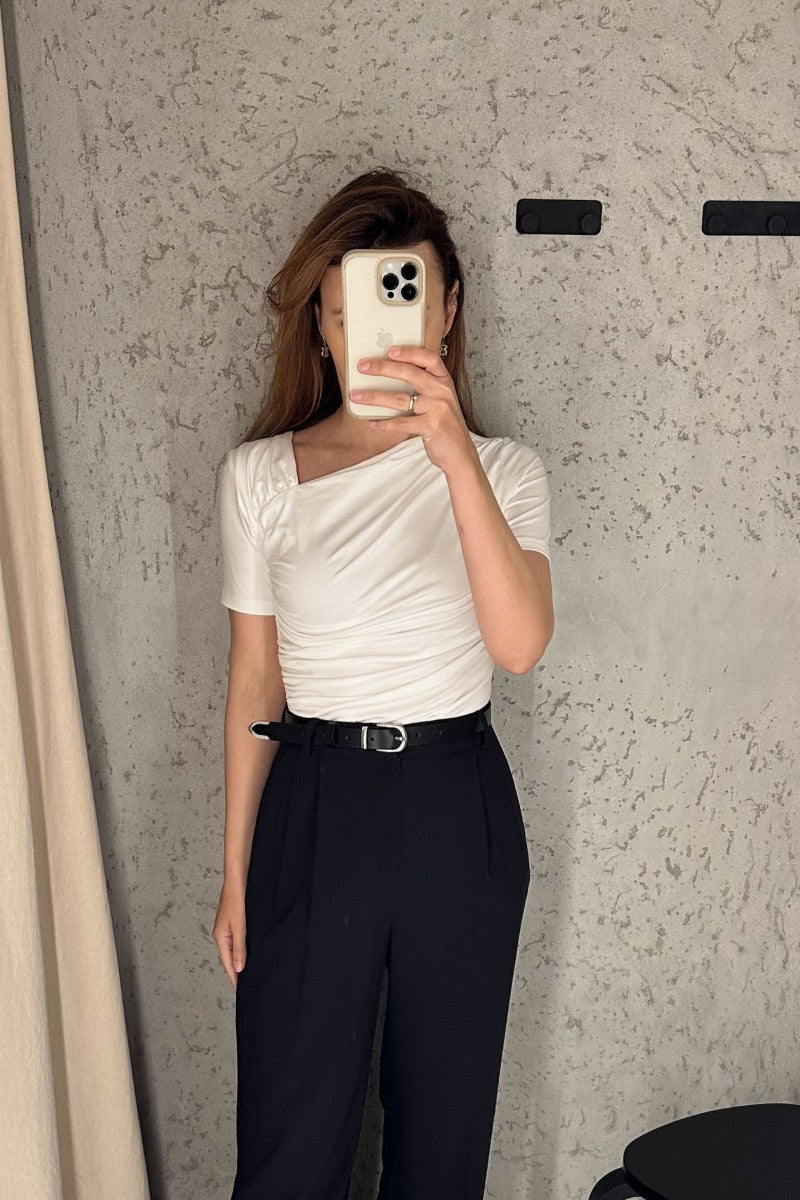 Cream blouse with asymmetric neckline and draping